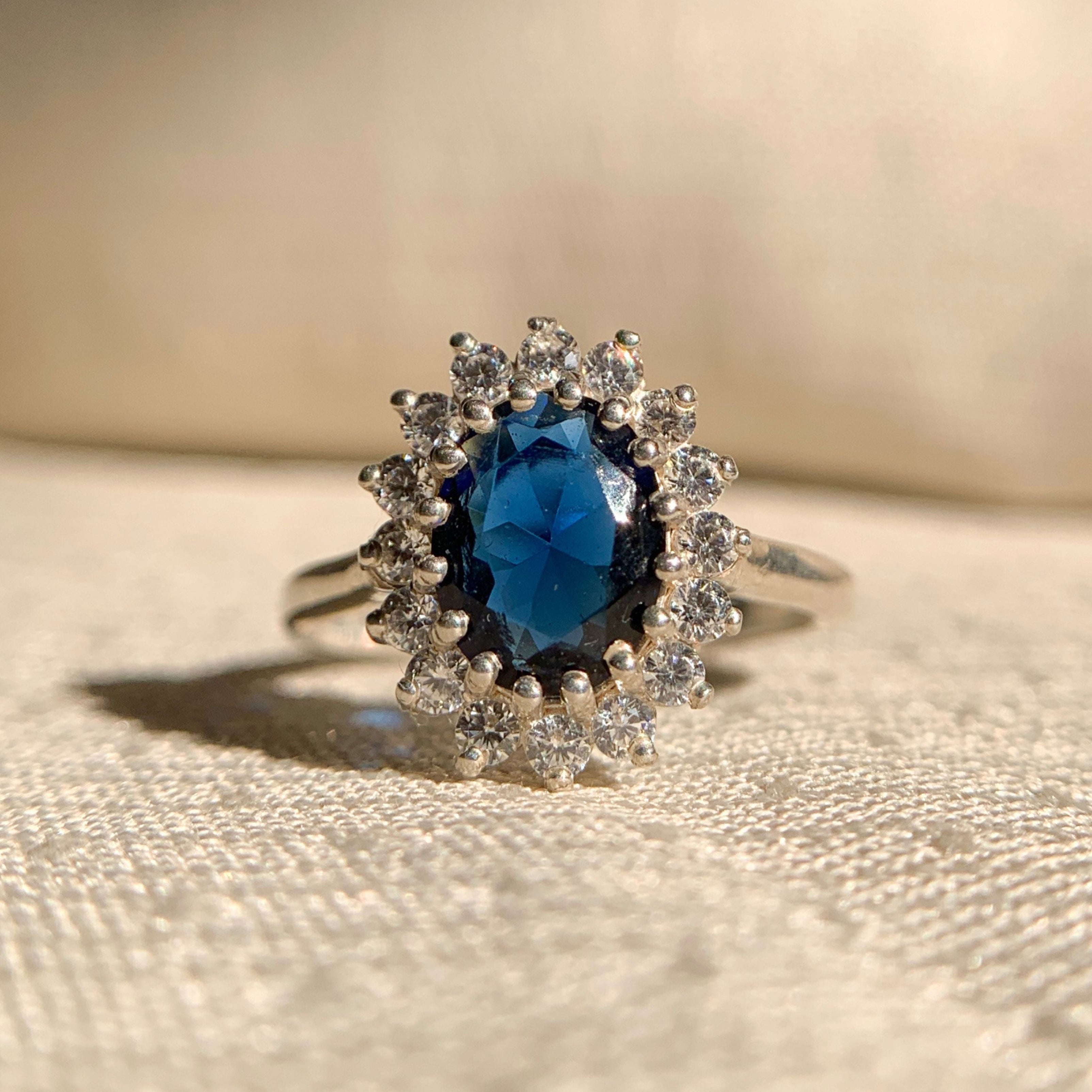 Elegant 14k gold oval blue sapphire ring with round diamond halo